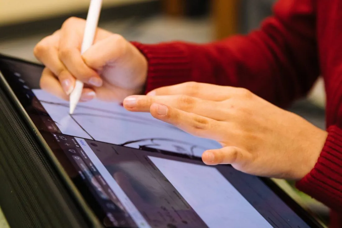 person using pencil to design on tablet scaled 1400x933 1